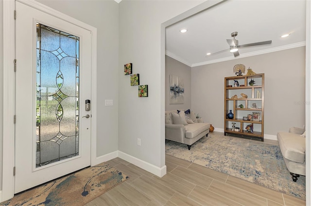 entryway with recessed lighting, crown molding, and baseboards