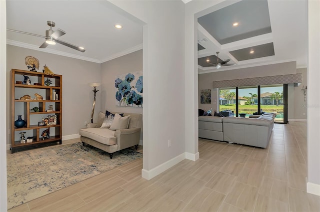 living area with ornamental molding, coffered ceiling, a ceiling fan, and baseboards