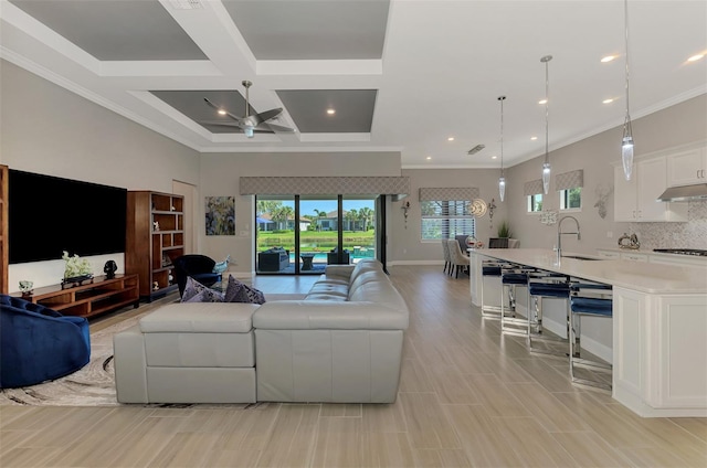 living area featuring baseboards, coffered ceiling, ornamental molding, a high ceiling, and recessed lighting