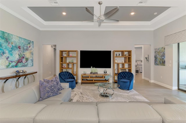 living area featuring ceiling fan, wood finished floors, visible vents, and crown molding