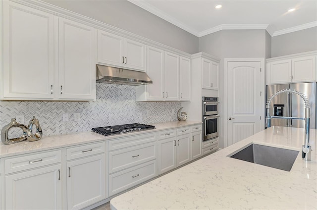 kitchen featuring crown molding, stainless steel appliances, white cabinetry, and under cabinet range hood