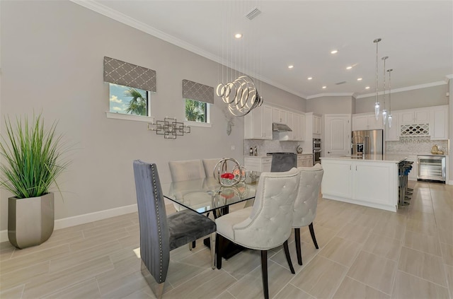 dining space featuring visible vents, wine cooler, baseboards, and crown molding