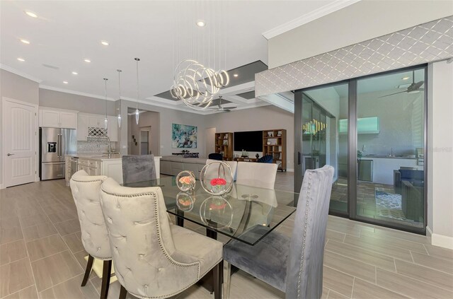 dining room with an inviting chandelier, baseboards, ornamental molding, and recessed lighting