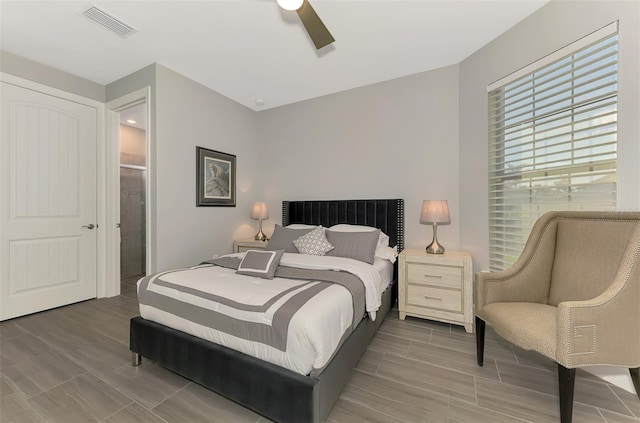 bedroom featuring ceiling fan, visible vents, and connected bathroom