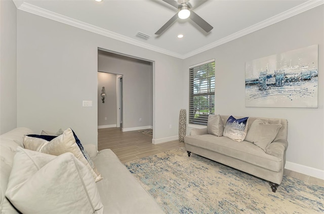 living area featuring ornamental molding, visible vents, baseboards, and wood finished floors