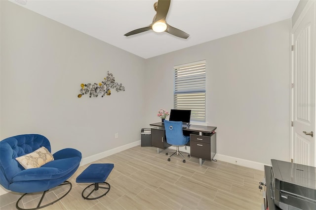 office with a ceiling fan, light wood-style floors, and baseboards