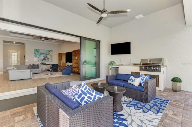 view of patio featuring outdoor lounge area, a sink, a ceiling fan, exterior kitchen, and grilling area