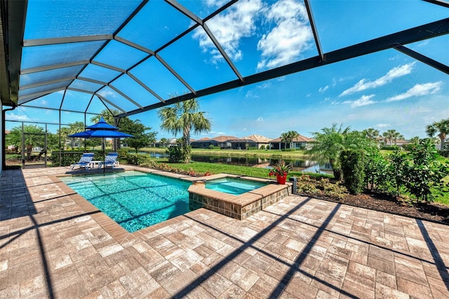 view of pool with glass enclosure, a pool with connected hot tub, and a patio