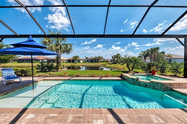 view of pool with a patio area, glass enclosure, a water view, and a pool with connected hot tub