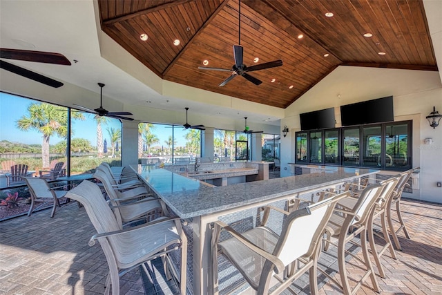 view of patio featuring a sink, a ceiling fan, and outdoor wet bar