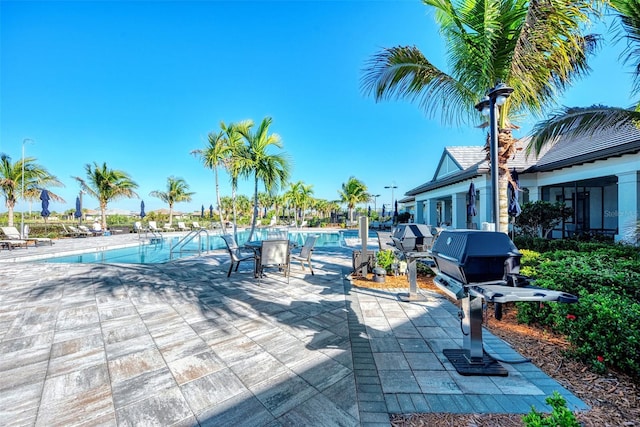 pool with a grill and a patio