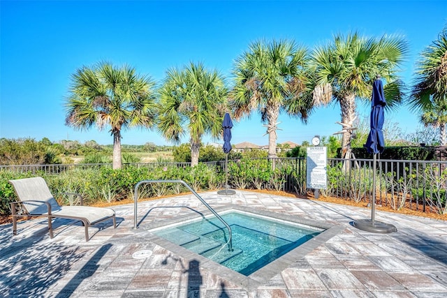 view of pool featuring fence and a patio