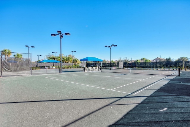 view of tennis court featuring fence