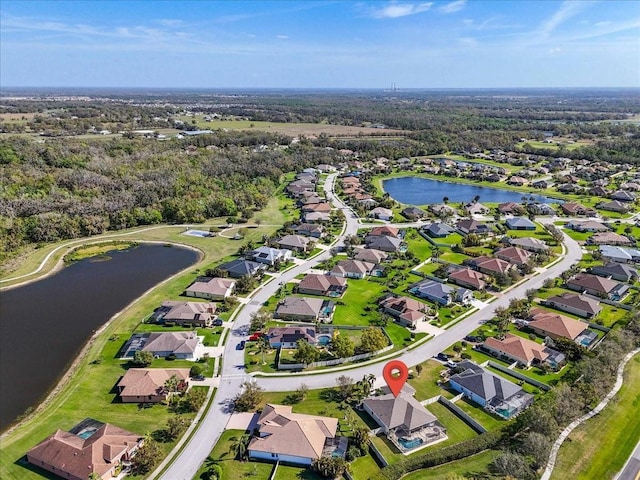 birds eye view of property featuring a water view and a residential view