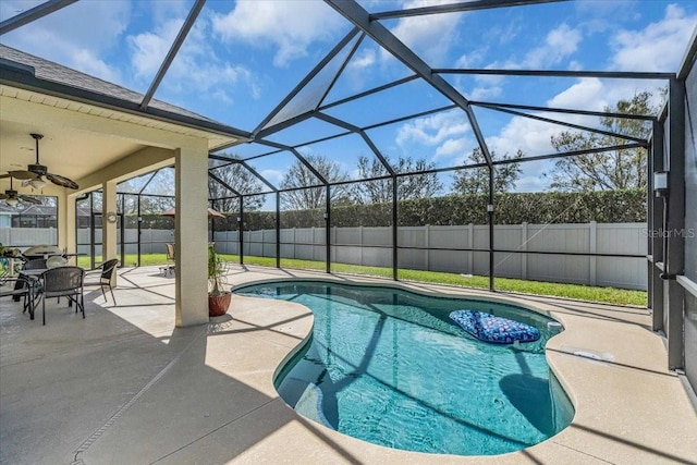 view of swimming pool featuring a patio area, a fenced backyard, and glass enclosure