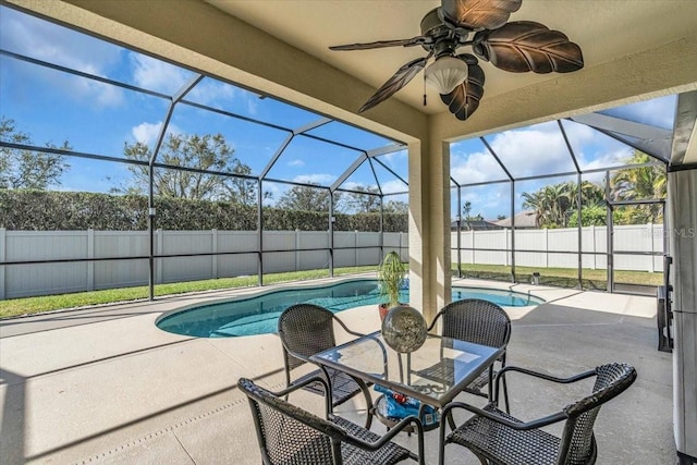 view of swimming pool with a fenced in pool, a patio, a ceiling fan, glass enclosure, and a fenced backyard