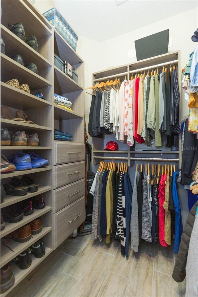 spacious closet with wood finish floors