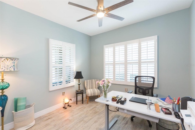 office area featuring baseboards, a ceiling fan, and wood finished floors