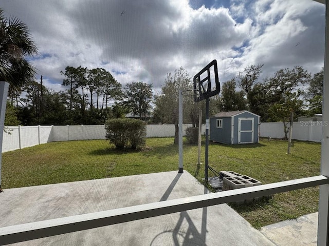 exterior space with a storage unit, a lawn, and a fenced backyard