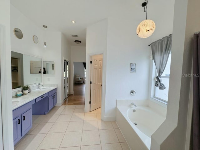 3650 S Sumter Blvd, North Port, FL 34287 - full bathroom featuring tile patterned floors, a bath, double vanity, baseboards, and a high ceiling