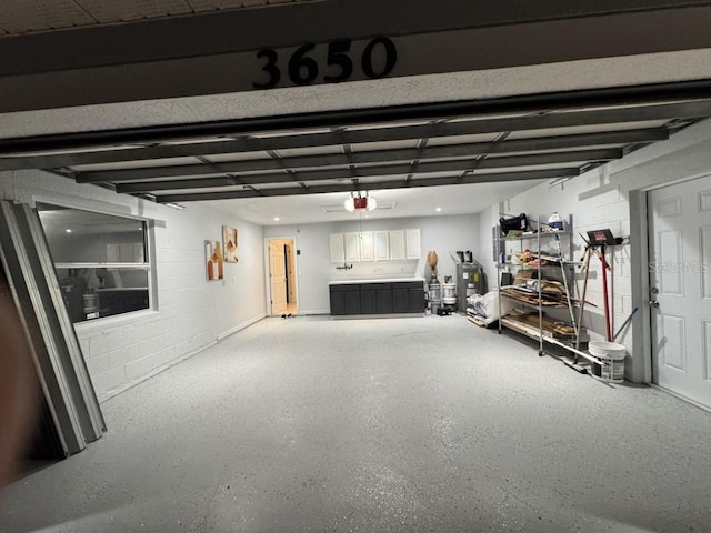 3650 S Sumter Blvd, North Port, FL 34287 - garage featuring concrete block wall and a garage door opener