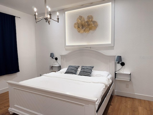 3650 S Sumter Blvd, North Port, FL 34287 - bedroom featuring light wood finished floors, a chandelier, and baseboards