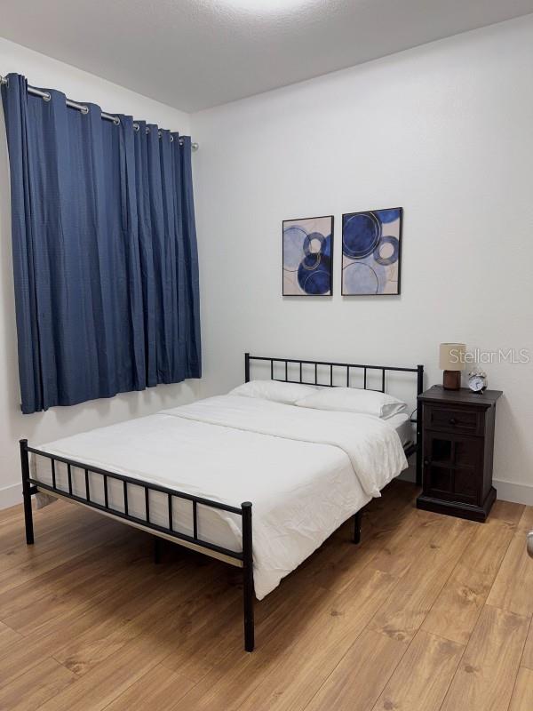 3650 S Sumter Blvd, North Port, FL 34287 - bedroom with wood finished floors and baseboards