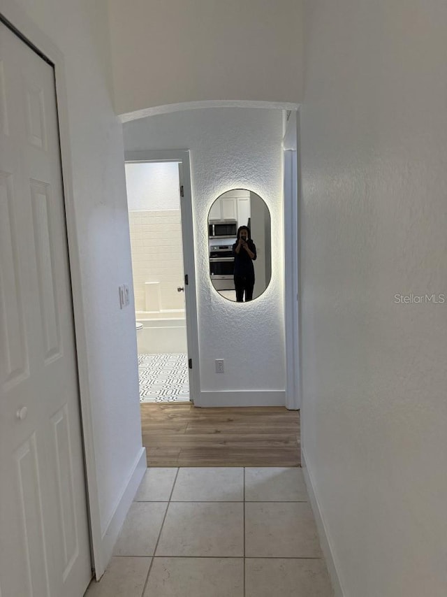 3650 S Sumter Blvd, North Port, FL 34287 - hallway with baseboards and light tile patterned flooring