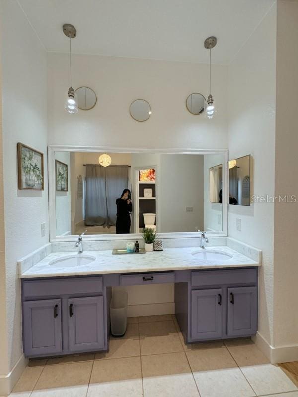 3650 S Sumter Blvd, North Port, FL 34287 - bathroom featuring double vanity, tile patterned flooring, and baseboards