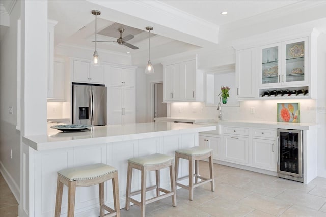 kitchen featuring beverage cooler, a kitchen breakfast bar, white cabinetry, and stainless steel refrigerator with ice dispenser