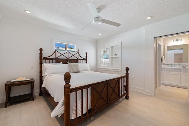 bedroom with ensuite bathroom, a textured ceiling, crown molding, and baseboards