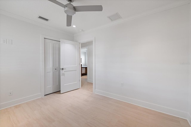 unfurnished bedroom featuring visible vents, baseboards, a closet, and crown molding