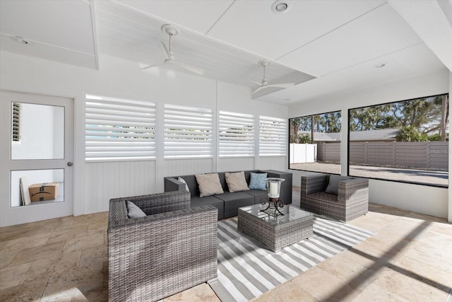 sunroom / solarium with a healthy amount of sunlight and a ceiling fan