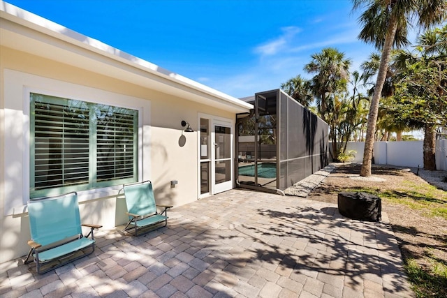 view of patio / terrace featuring a lanai and fence private yard