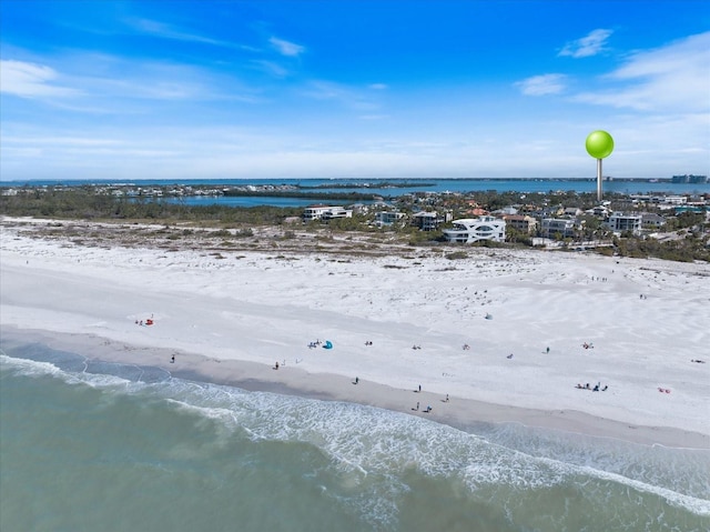 bird's eye view featuring a beach view and a water view