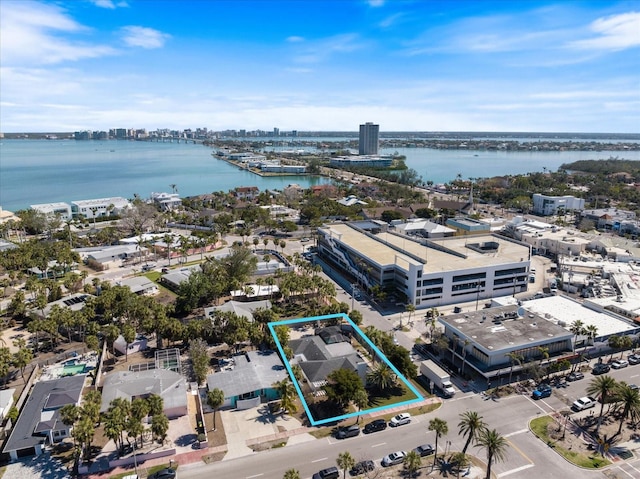 birds eye view of property with a water view and a view of city