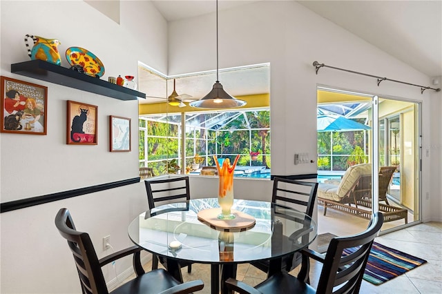 dining area with tile patterned flooring, a sunroom, and vaulted ceiling