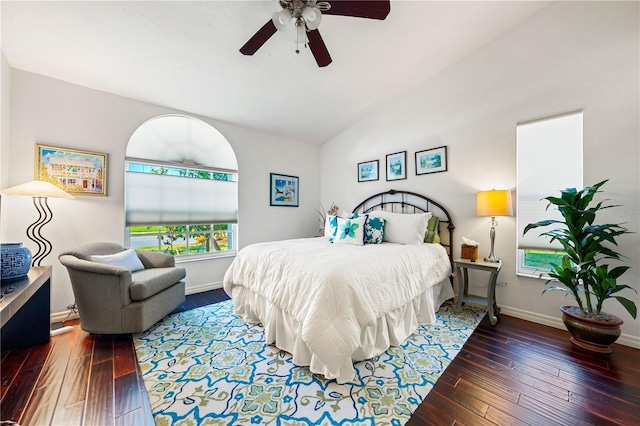 bedroom with vaulted ceiling, hardwood / wood-style floors, and baseboards