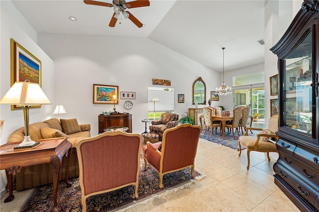 living room with high vaulted ceiling, light tile patterned flooring, visible vents, and ceiling fan with notable chandelier