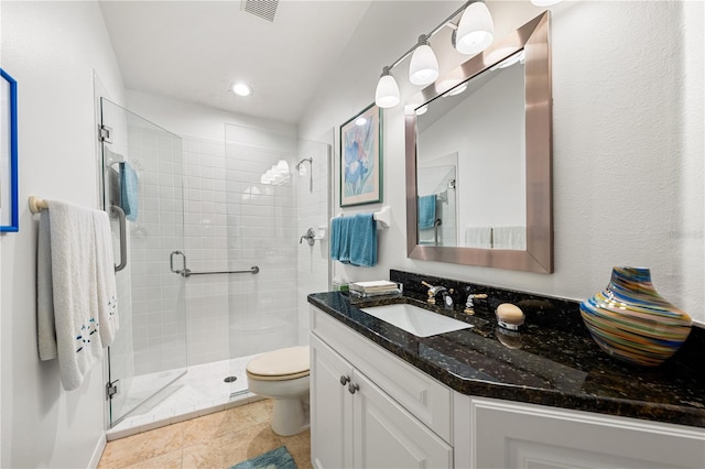 bathroom featuring tile patterned flooring, toilet, visible vents, vanity, and a stall shower