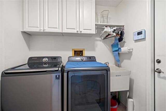 laundry area featuring cabinet space and washer and clothes dryer