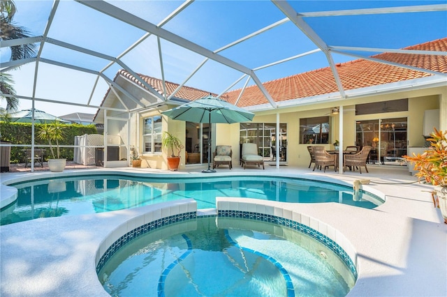 view of swimming pool with ceiling fan, a patio, a lanai, and a pool with connected hot tub