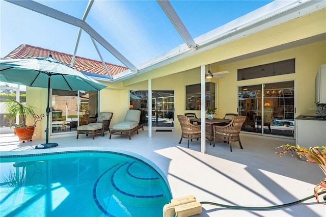 outdoor pool featuring a patio, a lanai, and a ceiling fan