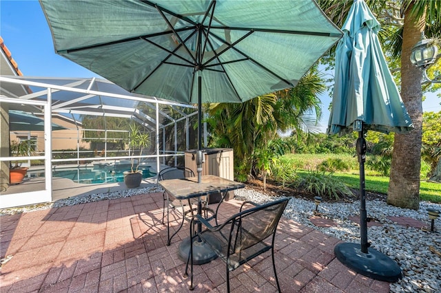 view of patio with a lanai, an outdoor pool, and outdoor dining space