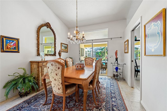 dining area with light tile patterned flooring, a notable chandelier, and baseboards