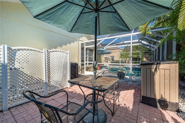 view of patio featuring glass enclosure and an outdoor pool