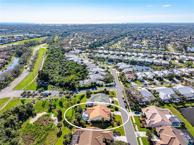 birds eye view of property featuring a water view and a residential view