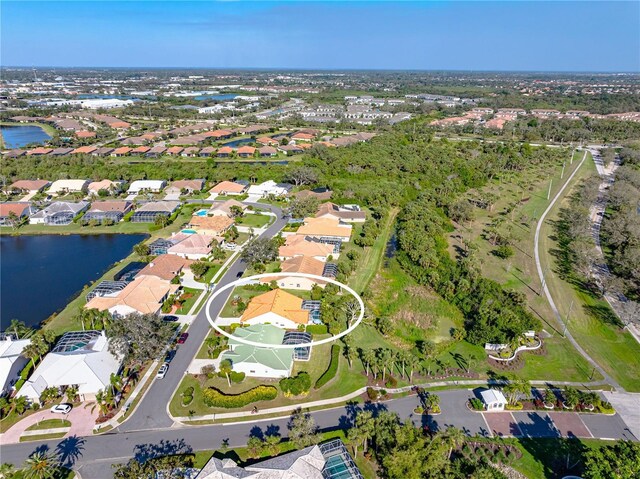 birds eye view of property with a water view and a residential view