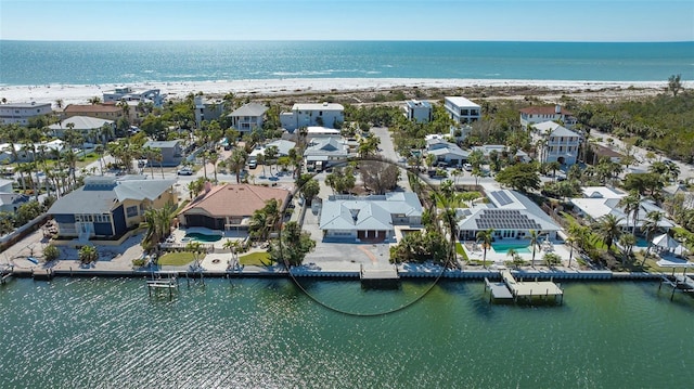 drone / aerial view with a water view and a residential view