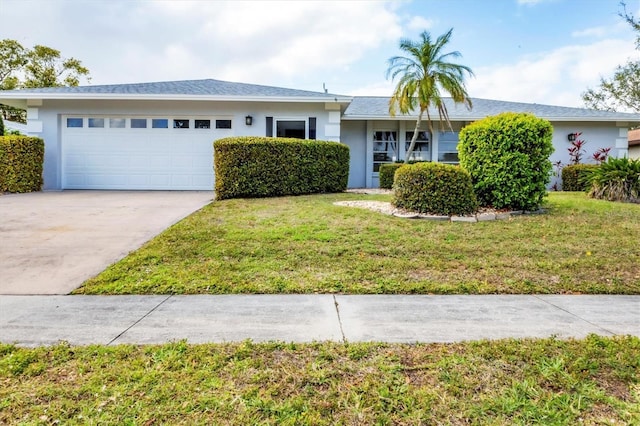 ranch-style house with stucco siding, driveway, a front yard, and an attached garage